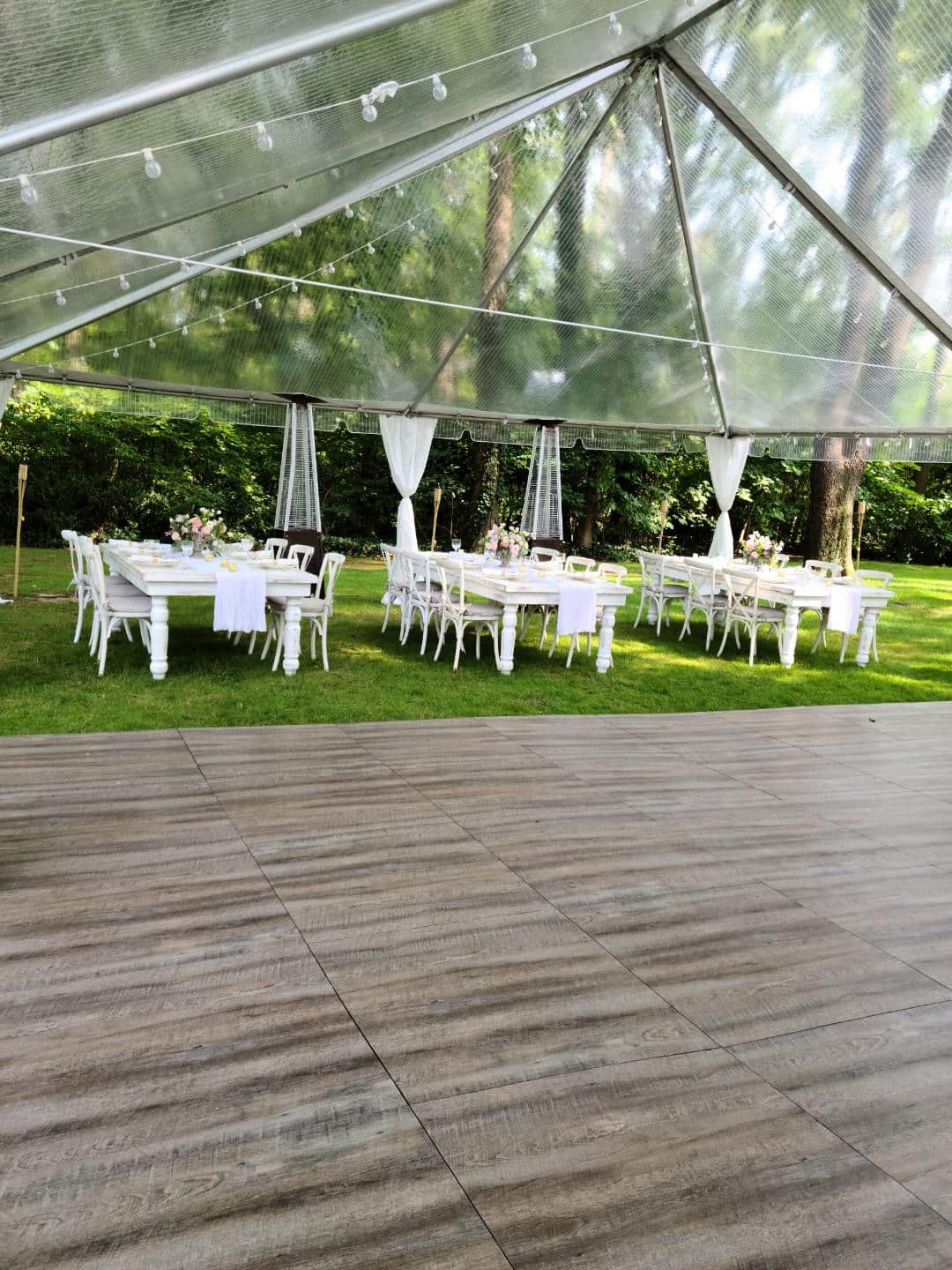 A wedding reception set up under a tent