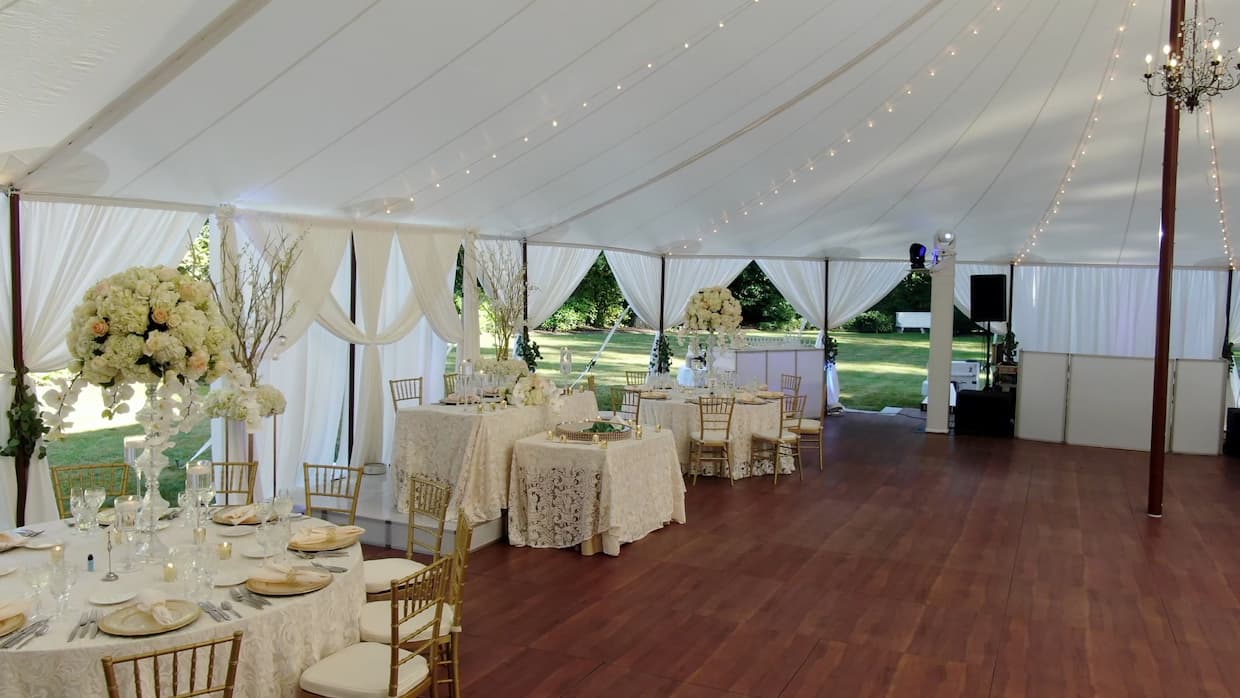 A wedding reception set up under a tent