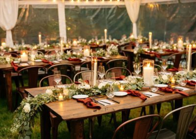 a rustic wedding tent, with tables and chairs set up inside