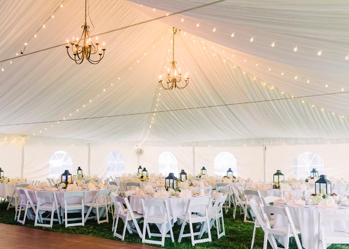 wedding tables set up under a wedding tent