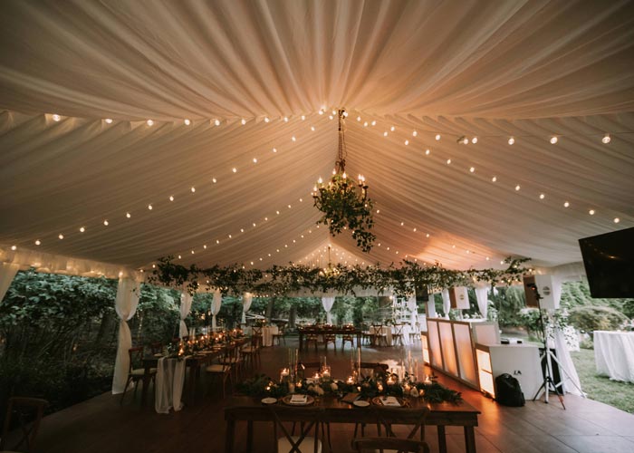 a wedding tent with lights inside it