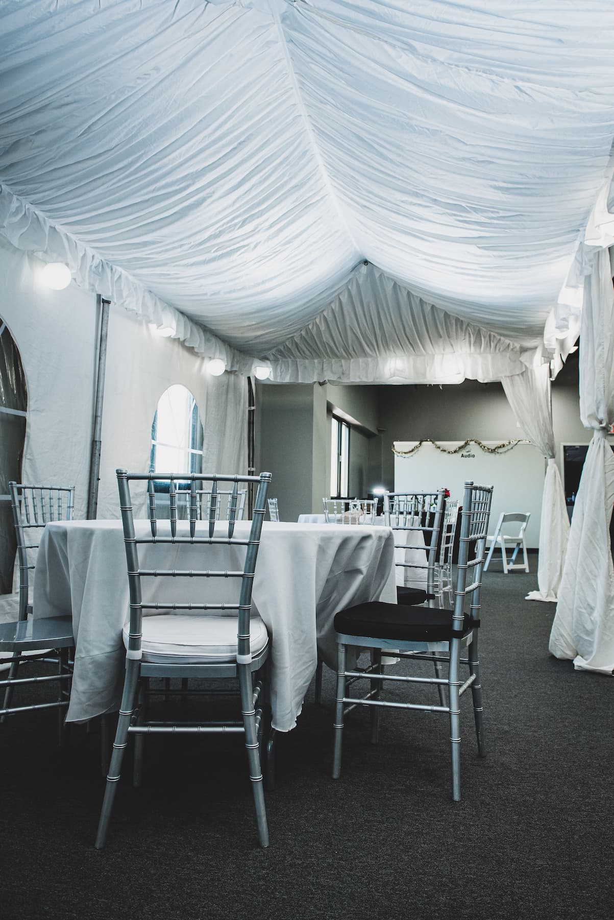 chairs set up under a wedding tent