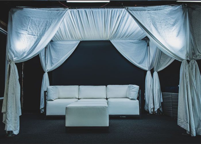 a lounge area set up under a wedding tent